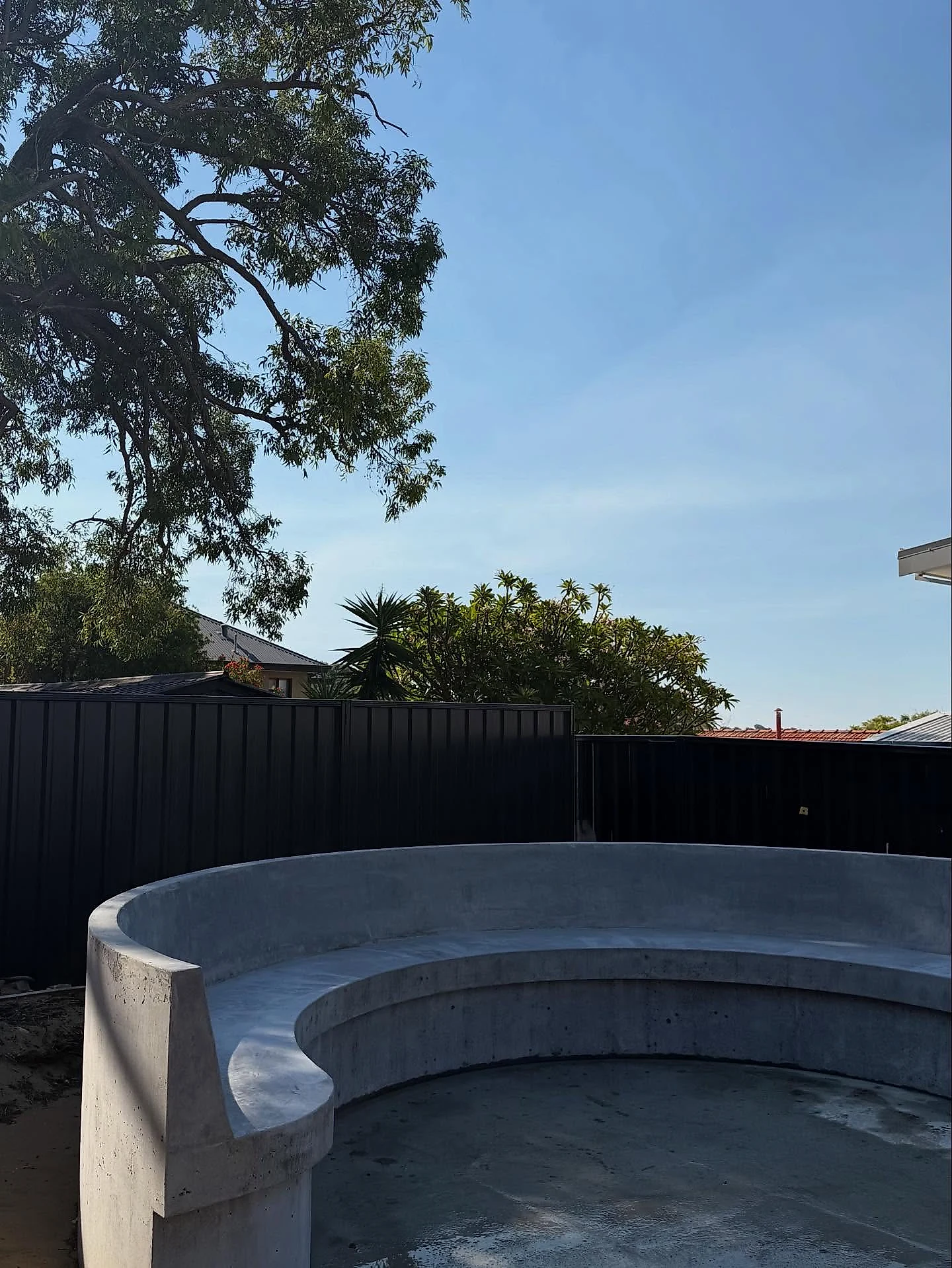 Curved architectural concrete on a new build, set out on site to follow the line of the landscaping rather tha