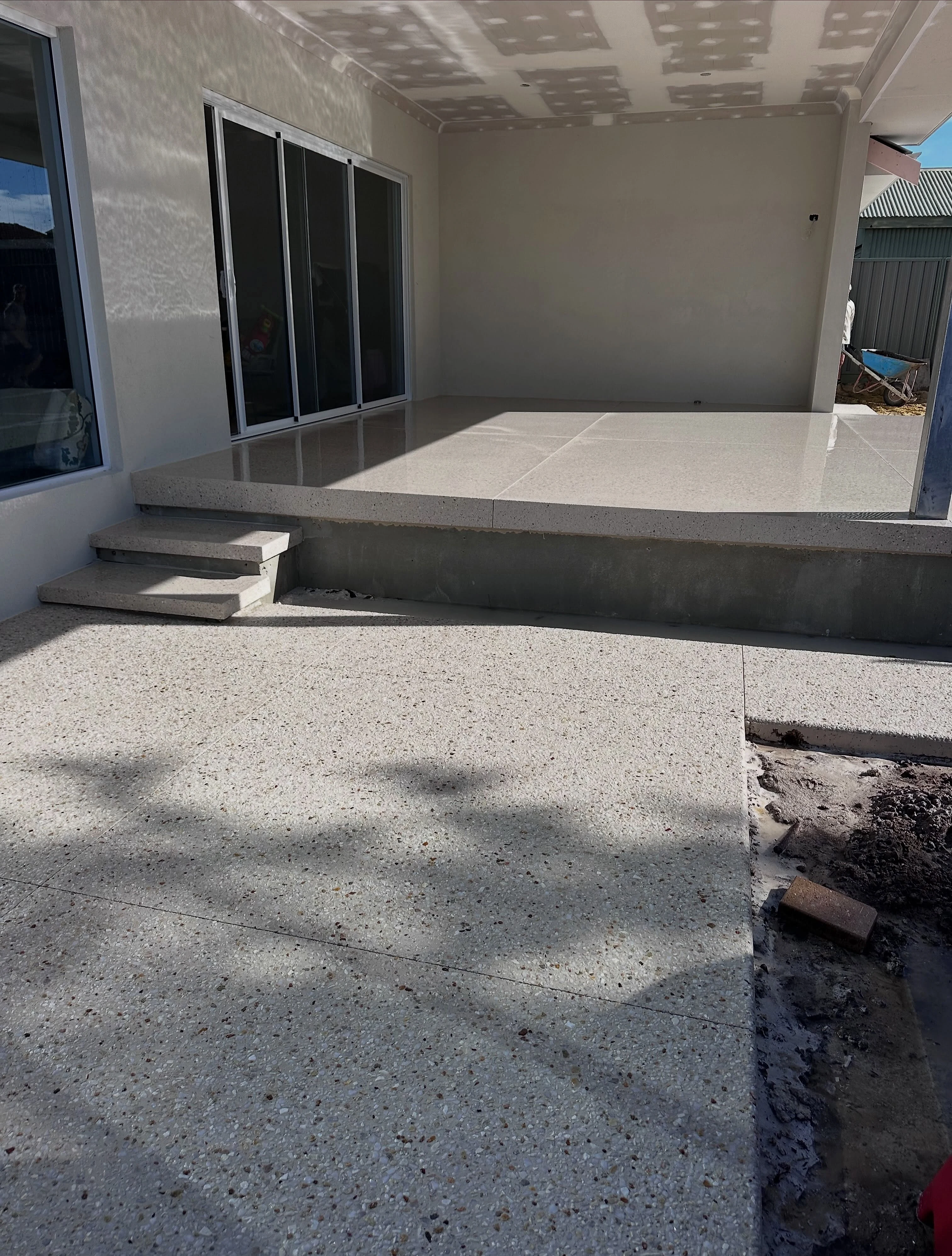 Honed alfresco in Limecrete Coral White at a Woodlands home, matched to the driveway at the front of the same 