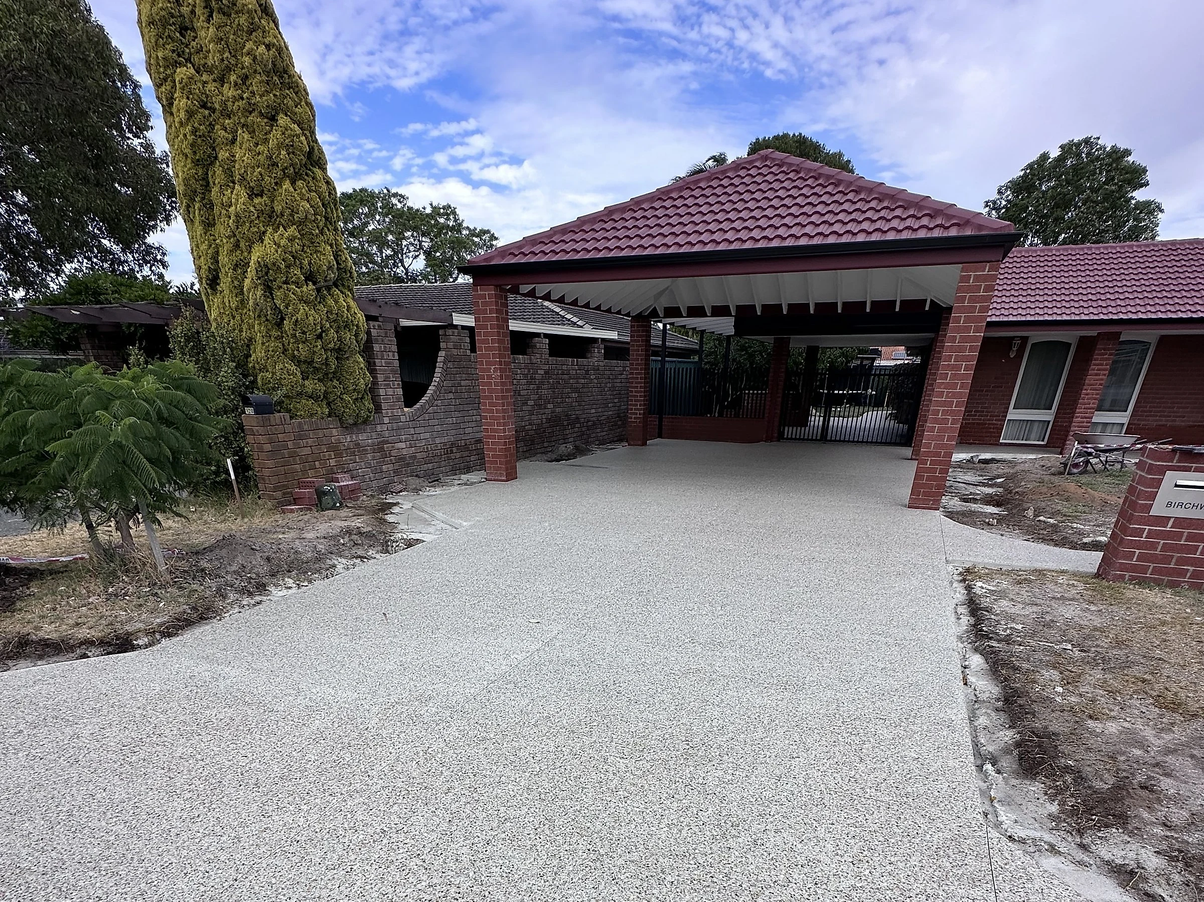 After: Tired original driveway and carport slab taken out and replaced with eucalyptus white exposed aggregate, carri