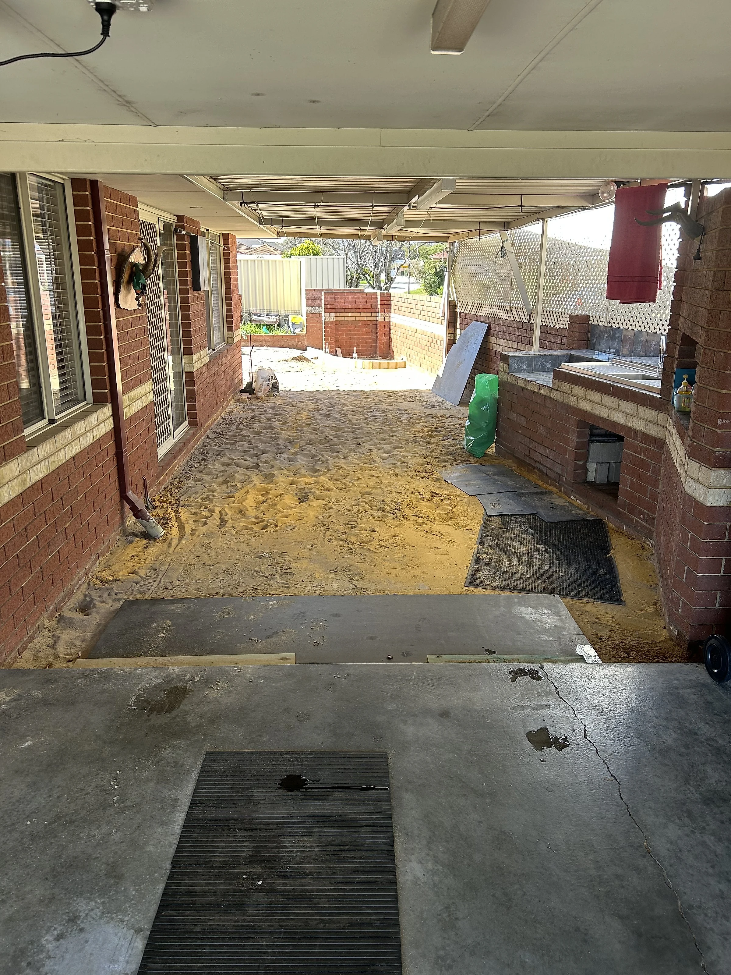 Before: 85 square metres of exposed aggregate around an established Wembley Downs home, taking in the driveway up to a