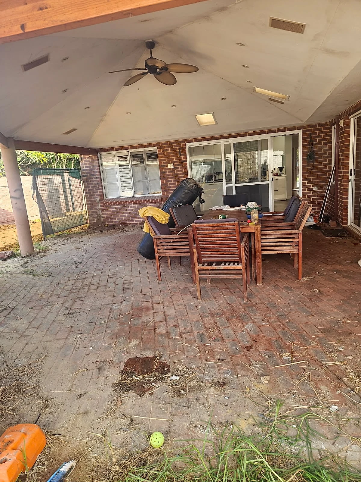 Before: An 85 square metre honed alfresco at a City Beach home in Limecrete Amber White, replacing old brick paving un