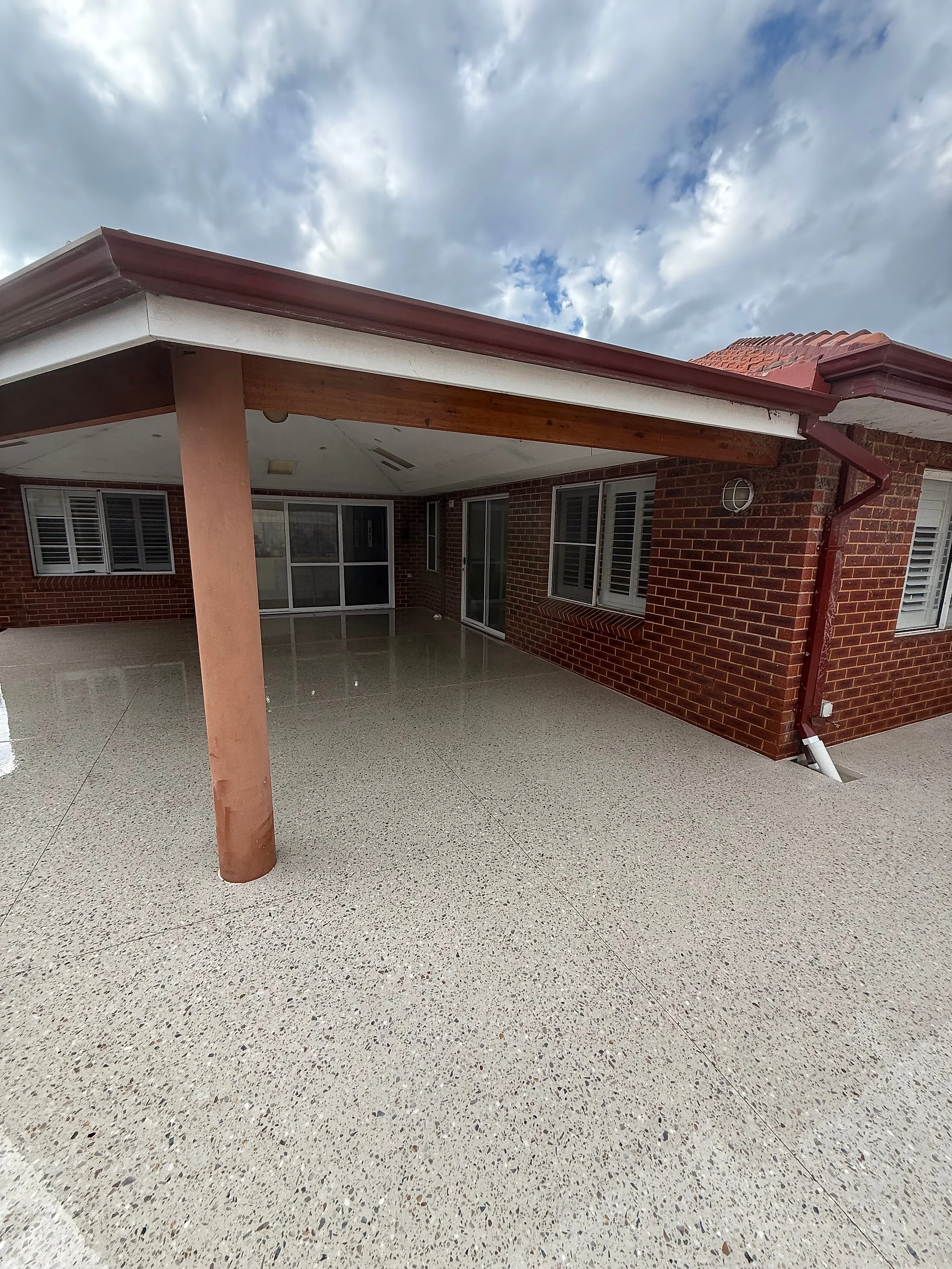 An 85 square metre honed alfresco at a City Beach home in Limecrete Amber White, replacing old brick paving un