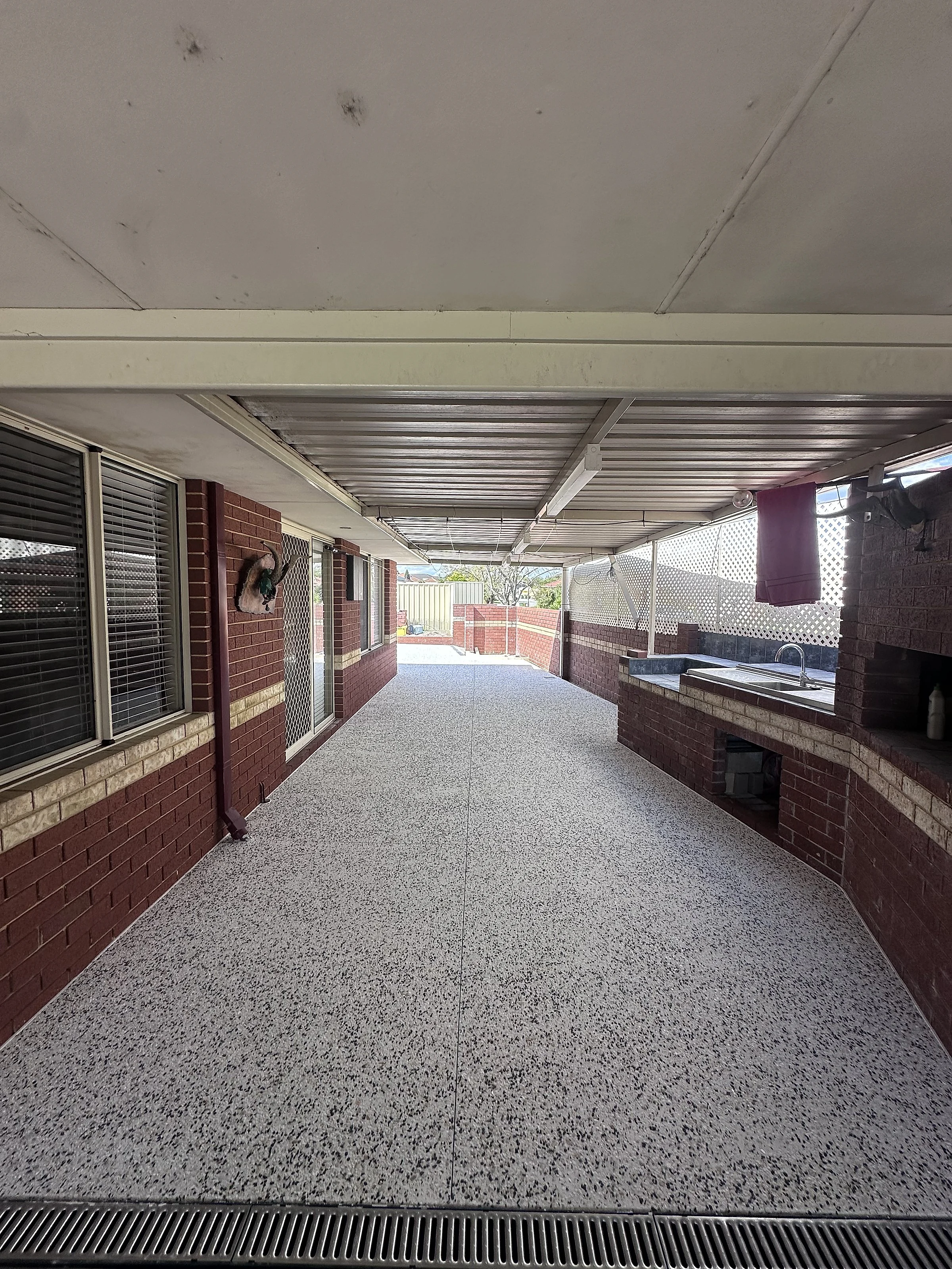 After: 85 square metres of exposed aggregate around an established Wembley Downs home, taking in the driveway up to a