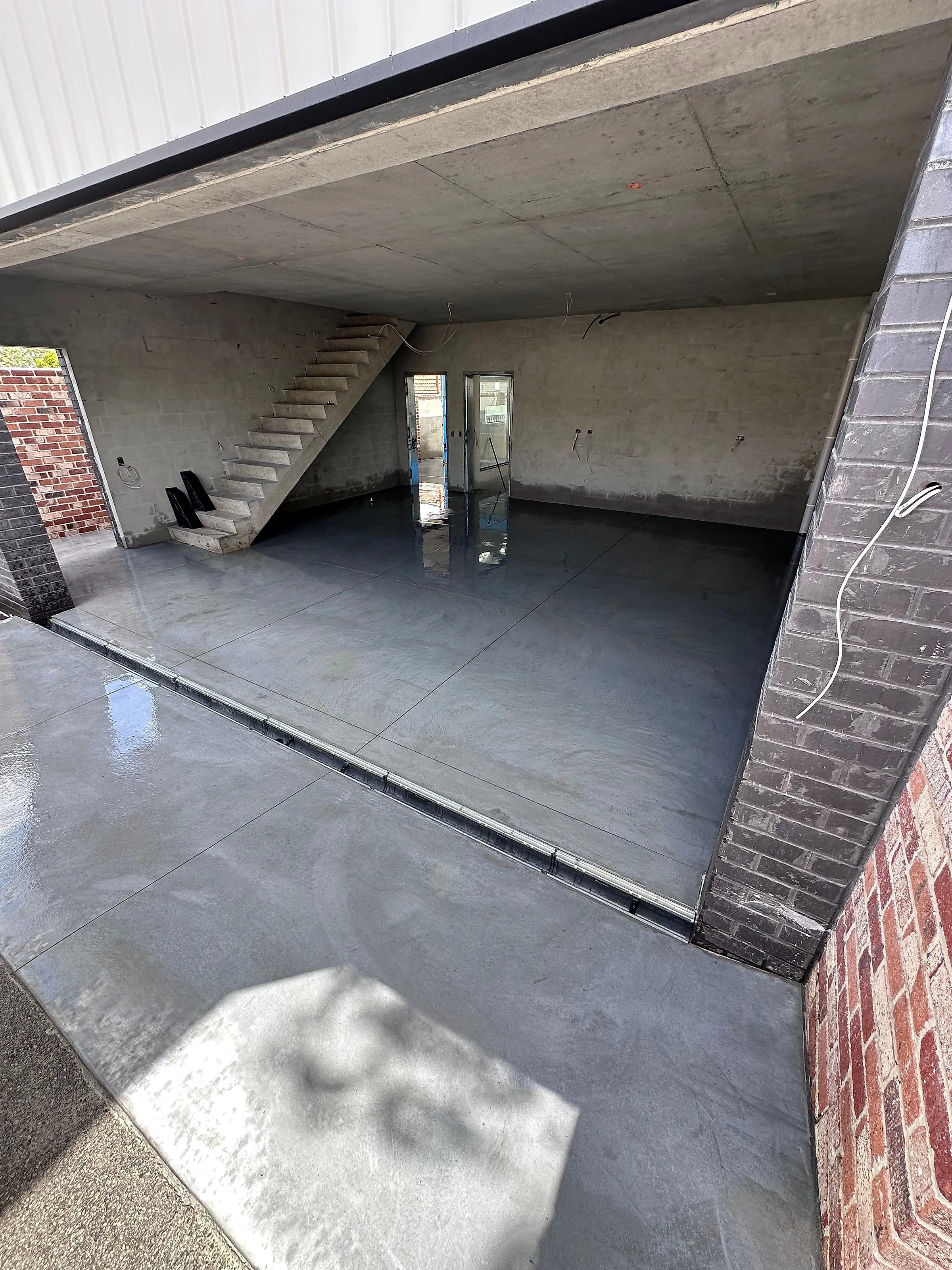 A burnished architectural grey entrance, alfresco and garage on a Churchlands rebuild, poured in Limecrete Arc