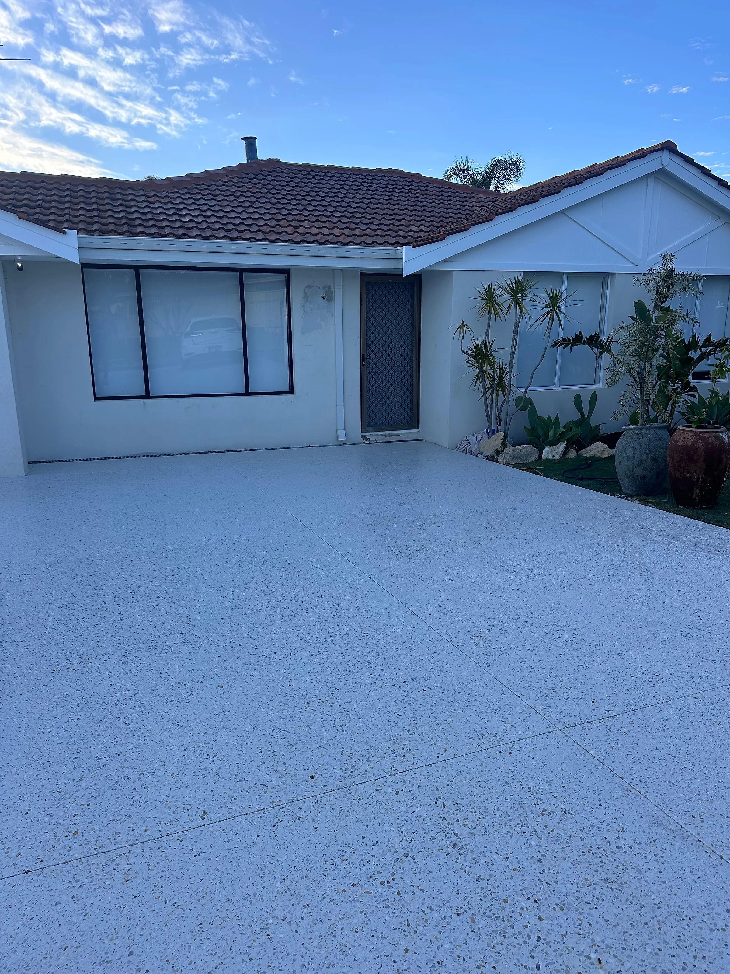 A honed driveway carried right through to a rear entertaining area on the same block, finished in the one pale
