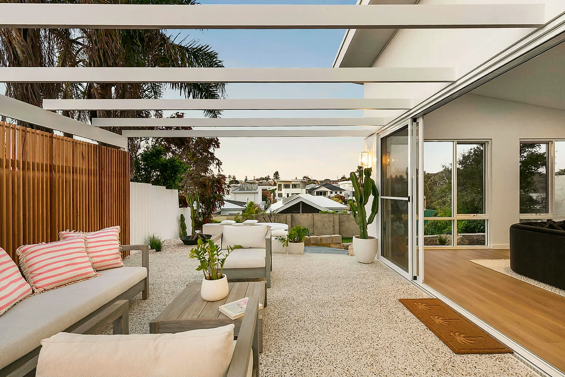 Open plan alfresco with exposed aggregate flooring at a North Beach renovation
