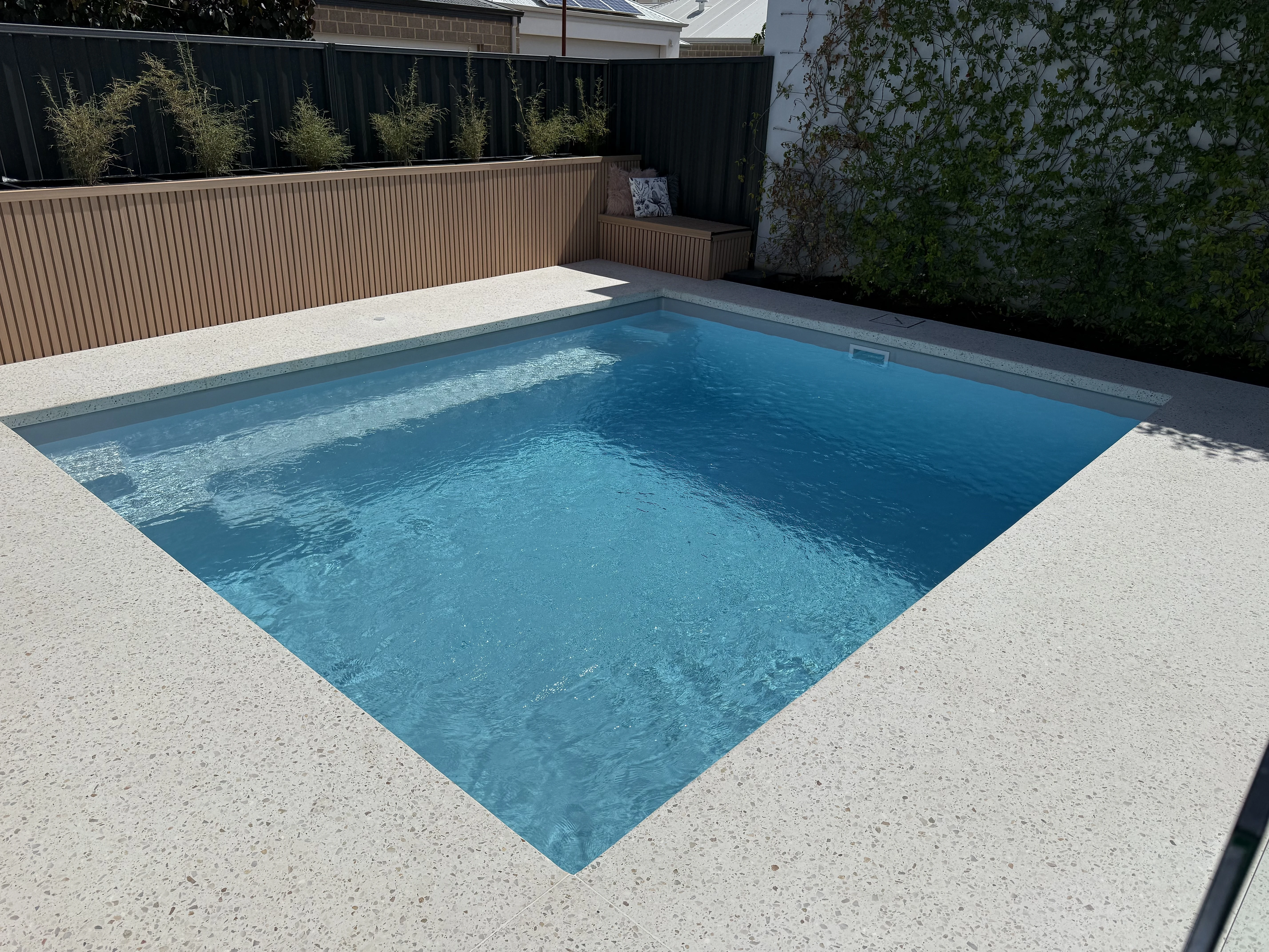 Pale exposed aggregate pool surround